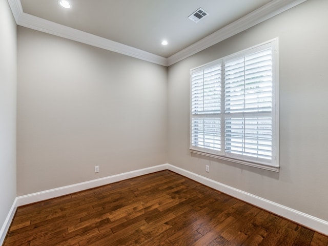 empty room featuring ornamental molding and dark wood-type flooring