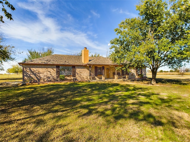 rear view of house featuring a lawn