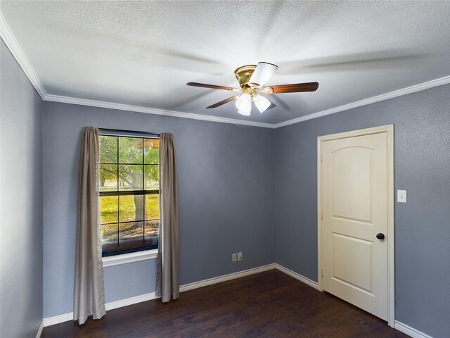 spare room featuring ceiling fan, dark wood-type flooring, and ornamental molding