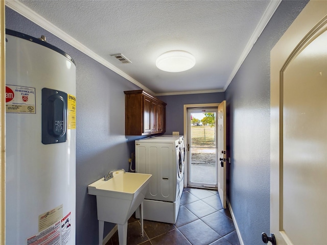 laundry area featuring cabinets, electric water heater, ornamental molding, a textured ceiling, and separate washer and dryer