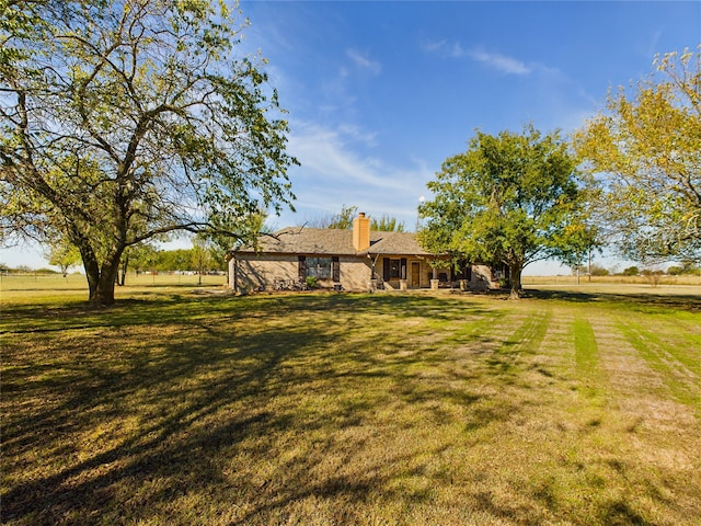 view of yard with a rural view