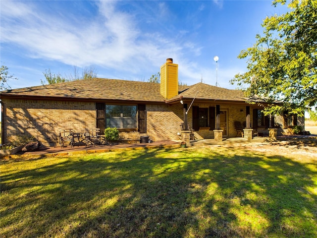 rear view of property with a yard and a patio