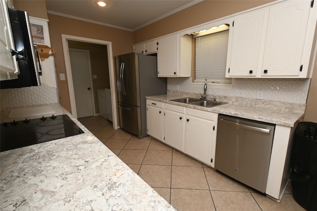 kitchen featuring appliances with stainless steel finishes, white cabinets, tasteful backsplash, and sink