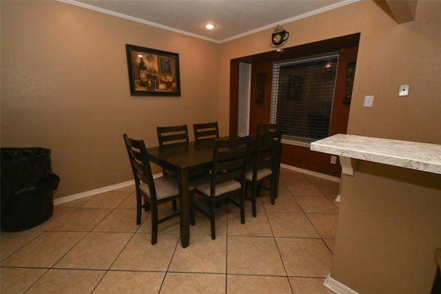 dining area featuring crown molding and light tile patterned floors