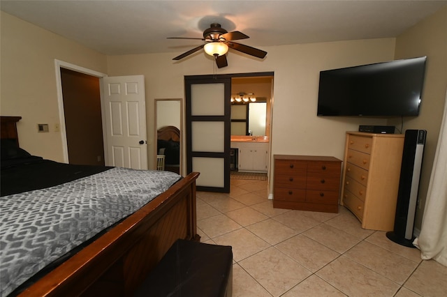 bedroom with sink, ceiling fan, light tile patterned flooring, and ensuite bath