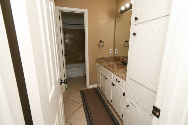 bathroom with vanity, toilet, and tile patterned flooring