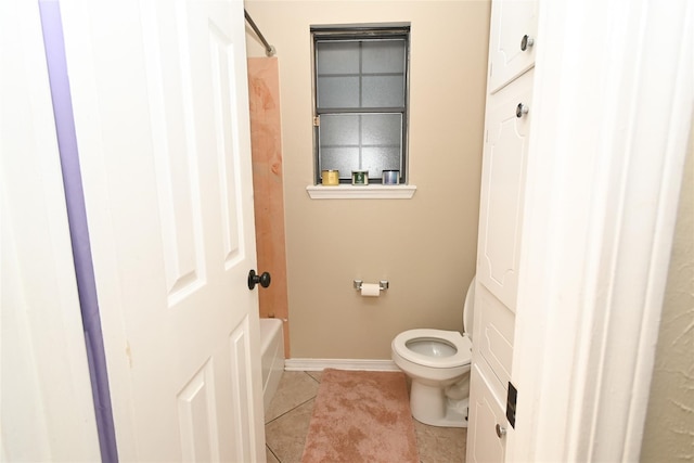 bathroom with shower / washtub combination, toilet, and tile patterned floors