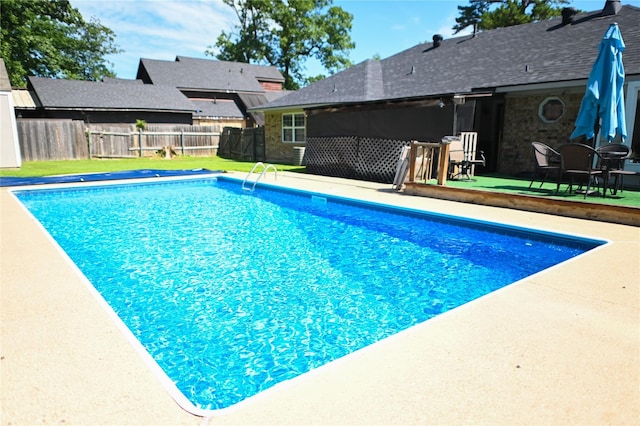 view of swimming pool with a patio area