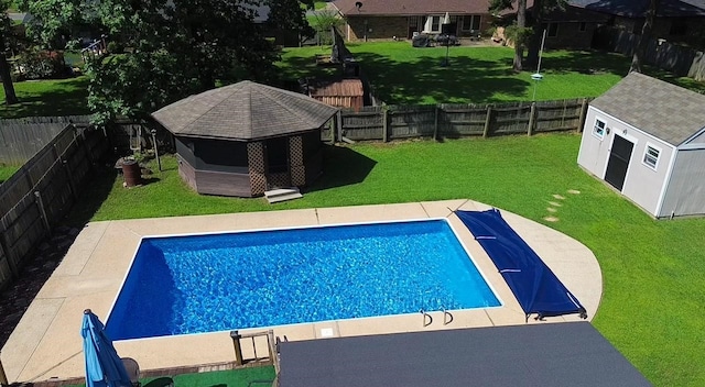 view of swimming pool with a yard and a shed