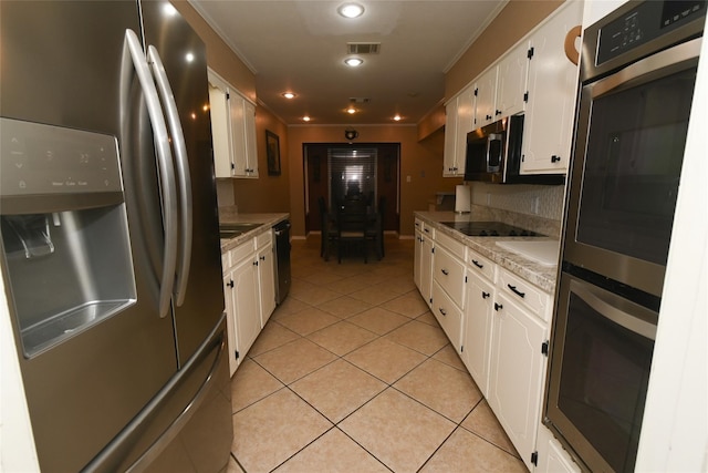 kitchen featuring appliances with stainless steel finishes, crown molding, white cabinets, and light tile patterned flooring