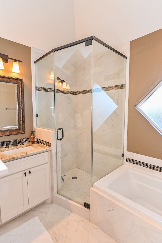 bathroom featuring vanity and shower with separate bathtub