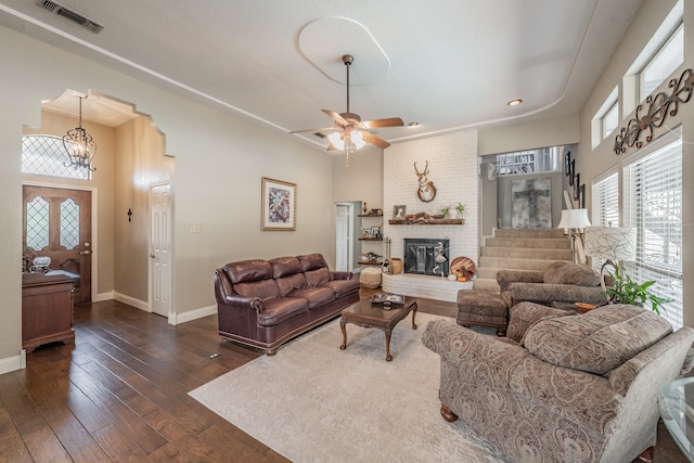 living room with ceiling fan, a fireplace, and dark hardwood / wood-style flooring