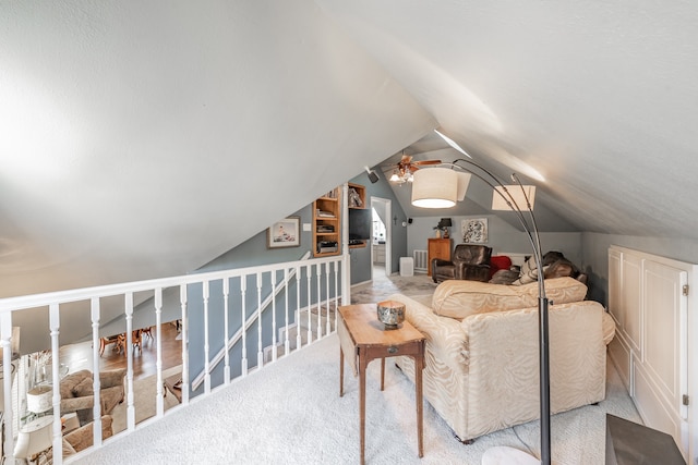 interior space with light carpet, lofted ceiling, and ceiling fan