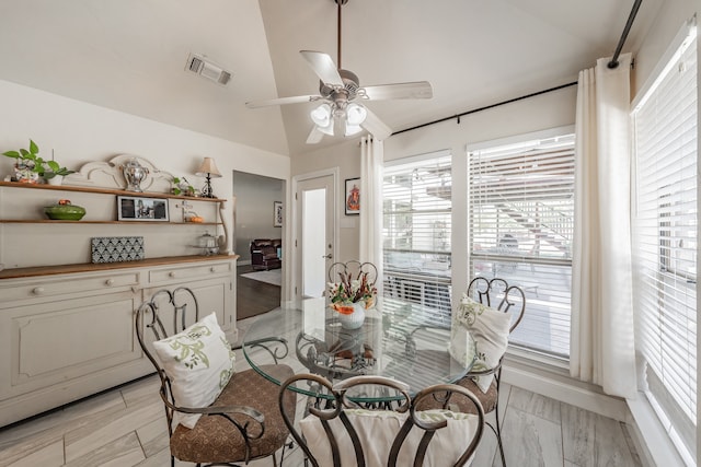 dining space featuring vaulted ceiling, light hardwood / wood-style floors, and ceiling fan