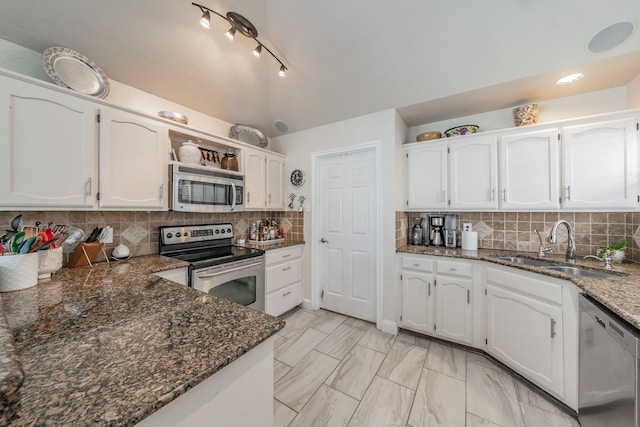 kitchen with backsplash, appliances with stainless steel finishes, and white cabinets