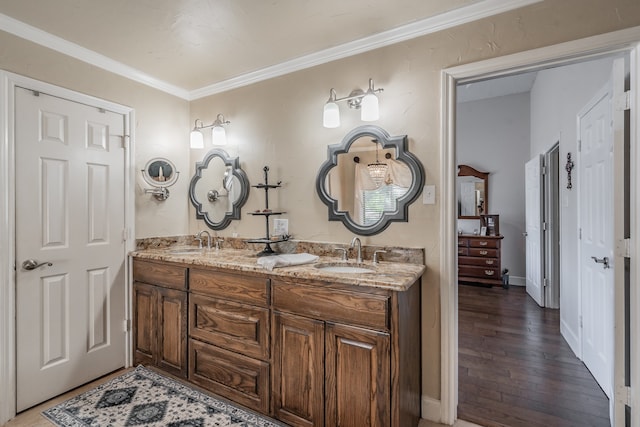 bathroom with vanity, crown molding, and hardwood / wood-style floors