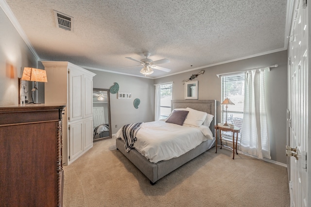 carpeted bedroom featuring ceiling fan, crown molding, and a textured ceiling