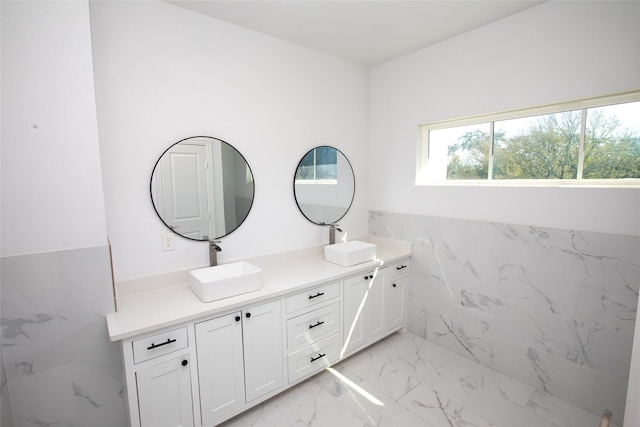 bathroom featuring vanity and tile walls