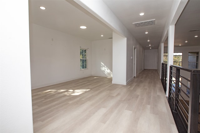 hallway with light hardwood / wood-style floors and plenty of natural light