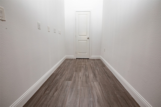 hallway with dark wood-type flooring