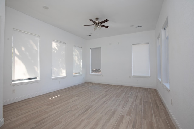 empty room with light hardwood / wood-style flooring and ceiling fan