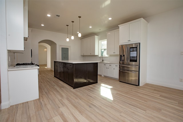 kitchen with a center island, stainless steel fridge with ice dispenser, pendant lighting, and white cabinets