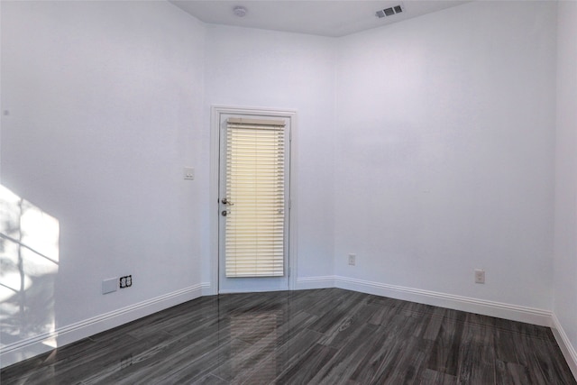 spare room featuring dark hardwood / wood-style flooring