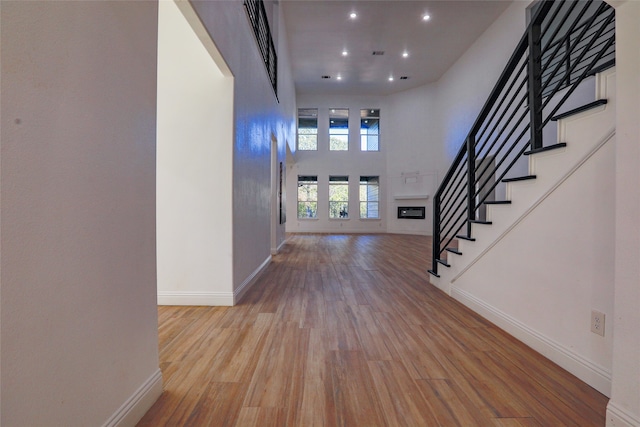 entrance foyer with a high ceiling and light hardwood / wood-style flooring