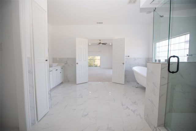 bathroom featuring tile walls, vanity, independent shower and bath, and ceiling fan