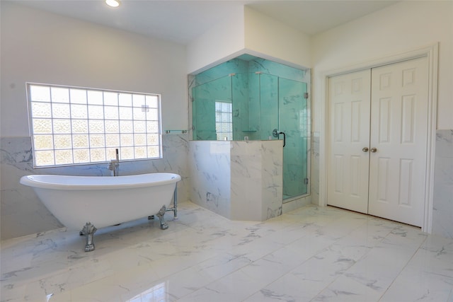 bathroom featuring tile walls and independent shower and bath