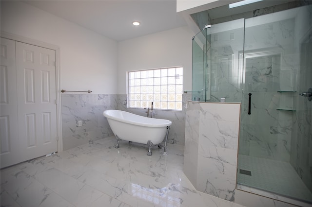 bathroom featuring independent shower and bath and tile walls