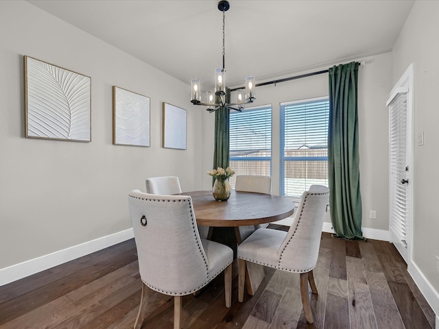 dining space featuring baseboards, dark wood-style flooring, and an inviting chandelier