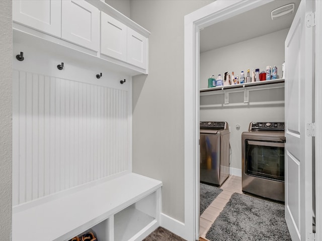 mudroom featuring washer and dryer and light hardwood / wood-style flooring