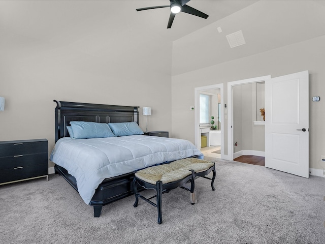 bedroom with high vaulted ceiling, carpet floors, ceiling fan, and connected bathroom