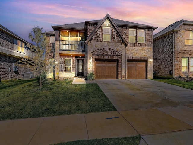 view of front of home featuring stone siding, brick siding, a balcony, and an attached garage