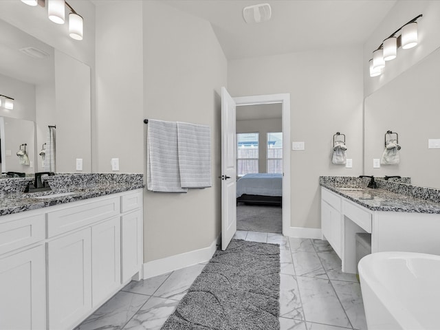 bathroom featuring a washtub and vanity