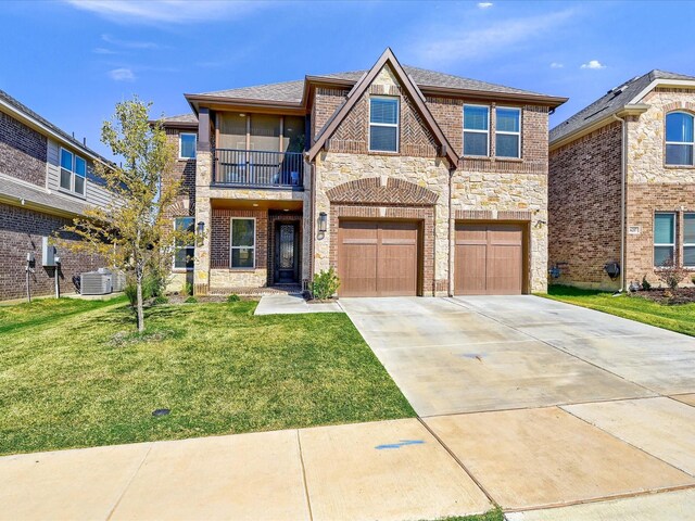 view of front of house with a garage, a front yard, and a balcony