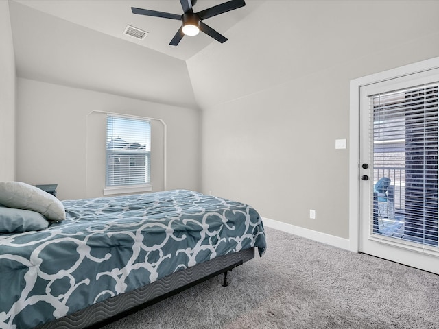 carpeted bedroom featuring access to outside, vaulted ceiling, and ceiling fan