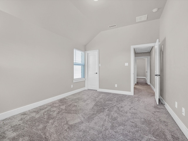 unfurnished bedroom featuring carpet floors and vaulted ceiling