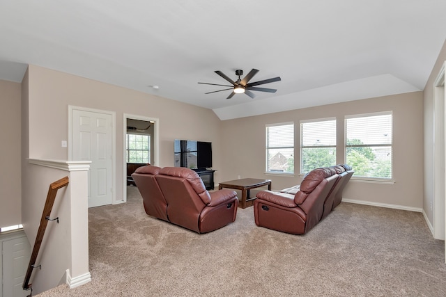 carpeted living room with ceiling fan and vaulted ceiling