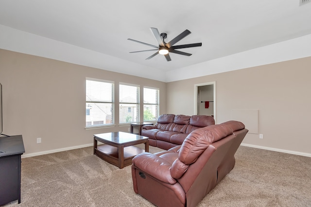 carpeted living room featuring ceiling fan