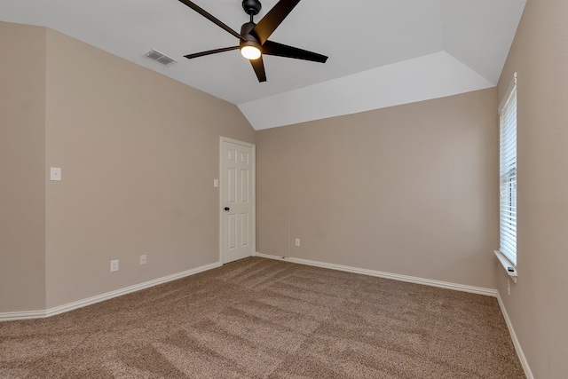 spare room with ceiling fan, carpet, and vaulted ceiling