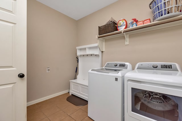 laundry room featuring washer and dryer and light tile patterned floors