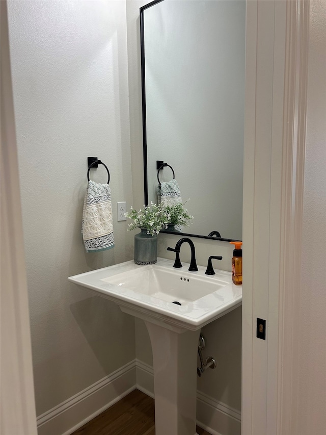 bathroom with sink and wood-type flooring