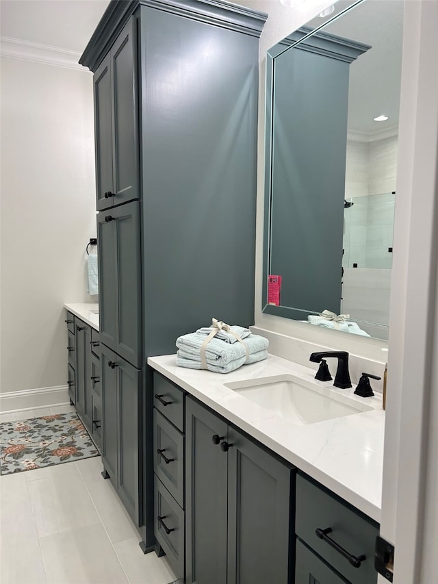 bathroom featuring tile patterned flooring, vanity, and ornamental molding