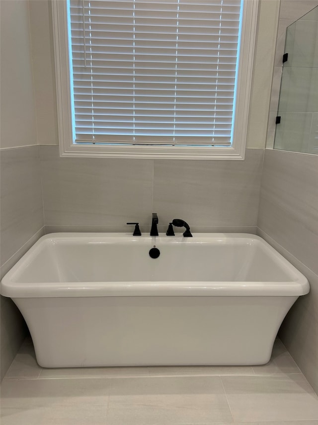 bathroom featuring a bathing tub and tile patterned flooring