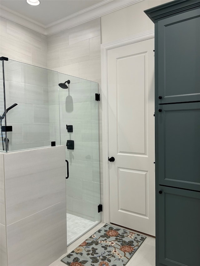 bathroom featuring tile patterned floors, crown molding, and walk in shower