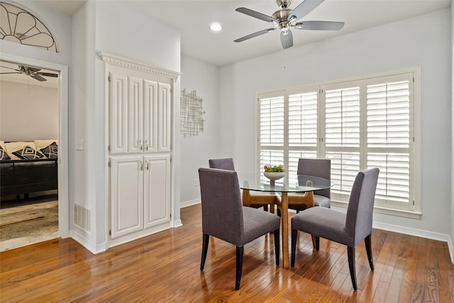 dining area with ceiling fan and light wood-type flooring