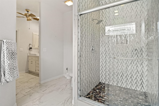 bathroom with a shower with door, toilet, ceiling fan, and vanity