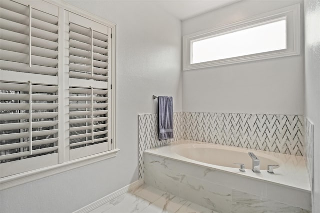 bathroom featuring tiled bath